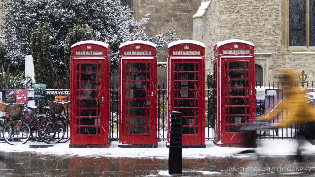 Phone Boxes and cyclist in the Snow on St Mary's Street Cambridge